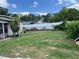 Large backyard with a chain link fence, grassy areas, and partial privacy fencing at 1009 Kenmore Dr, Brandon, FL 33510