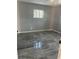 Bedroom with tile flooring, grey painted walls, and natural light at 1009 Kenmore Dr, Brandon, FL 33510