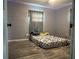 Bedroom featuring gray walls and floor with a queen size bed at 1009 Kenmore Dr, Brandon, FL 33510