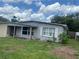 Exterior of home with blue sky and landscaped yard, offering a peaceful view at 1009 Kenmore Dr, Brandon, FL 33510