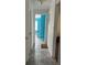 Hallway offering view of tile floors, neutral paint, and doorway to bright room, creating a welcoming space at 1009 Kenmore Dr, Brandon, FL 33510