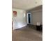 A well-lit living room with white walls and terrazzo floors, offering a simple and clean living space at 1009 Kenmore Dr, Brandon, FL 33510