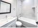 The bathroom features a tub shower combo with modern tile surround, vanity and a framed mirror at 17381 Tyler Ave, Port Charlotte, FL 33948