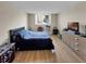 This bedroom features a large window, hardwood flooring, and neutral colored walls at 2700 Coconut Bay Ln # 419, Sarasota, FL 34237