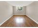 Inviting bedroom with laminate floors, a window, and neutral paint, creating a calming atmosphere at 2700 Coconut Bay Ln # 419, Sarasota, FL 34237