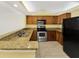 Modern kitchen with stainless steel appliances, granite countertops and wooden cabinets at 2700 Coconut Bay Ln # 419, Sarasota, FL 34237