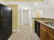 Kitchen has granite counters, black appliances, and open access to other rooms at 2700 Coconut Bay Ln # 419, Sarasota, FL 34237