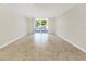 Bright and airy living room featuring tile flooring and sliding glass doors to the balcony at 2700 Coconut Bay Ln # 419, Sarasota, FL 34237