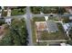 High aerial perspective of a fenced home, nestled amongst trees and neighborhood streets at 6315 Hillview Rd, Spring Hill, FL 34606