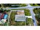 Aerial view of a corner lot property with a light blue house, fenced yard, and spacious layout at 6315 Hillview Rd, Spring Hill, FL 34606