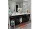 Bathroom features double sinks with granite countertops and dark wood cabinets at 6315 Hillview Rd, Spring Hill, FL 34606