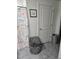 Bathroom includes gray tiled floors, and a shower/tub with a nautical-themed shower curtain at 6315 Hillview Rd, Spring Hill, FL 34606