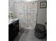 Bathroom with a vanity, gray tiled floors, and a shower/tub with a nautical-themed shower curtain at 6315 Hillview Rd, Spring Hill, FL 34606