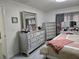 Bedroom showcasing a stylish dresser with a mirror and a comfortable bed with soft-toned linens at 6315 Hillview Rd, Spring Hill, FL 34606