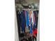 Closet features a closet rod with multiple hangers and items on the floor at 6315 Hillview Rd, Spring Hill, FL 34606