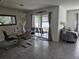 Dining area with modern light fixture and sliding glass doors to the outdoor space at 6315 Hillview Rd, Spring Hill, FL 34606