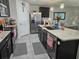 Kitchen features stainless steel appliances, dark cabinetry, and a granite countertop island at 6315 Hillview Rd, Spring Hill, FL 34606