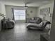 Living room with chandelier, tile floors, and grey seating at 6315 Hillview Rd, Spring Hill, FL 34606