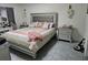 Bedroom featuring a large bed with a tufted headboard, side tables, and modern decor at 6315 Hillview Rd, Spring Hill, FL 34606
