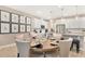 Elegant dining area with a round table, pendant lighting, and modern decor at 9005 Players Dr, Weeki Wachee, FL 34613
