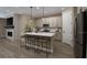 Modern kitchen featuring an island with seating, stainless steel appliances, and stylish lighting at 9226 Players Dr, Weeki Wachee, FL 34613