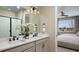 Elegant bathroom featuring double sinks, quartz counters, framed mirrors, and a glass-enclosed shower at 9275 Players Dr, Weeki Wachee, FL 34613