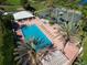 Beautiful aerial view of a community pool featuring palm trees and ample seating at 9275 Players Dr, Weeki Wachee, FL 34613