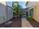 Charming backyard with a lush garden, pathway, and screened in patio leading to a sparkling pool at 1103 Kensington Ct, Safety Harbor, FL 34695