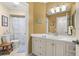Well-maintained bathroom features a vanity with ample storage, a tub with shower, and neutral decor at 1103 Kensington Ct, Safety Harbor, FL 34695