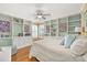 Inviting bedroom with built-in bookshelves, hardwood floors, and lots of natural light at 1103 Kensington Ct, Safety Harbor, FL 34695