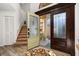 Inviting foyer with hardwood floors, staircase, and an open view to the front entrance at 1103 Kensington Ct, Safety Harbor, FL 34695