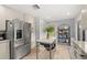 Bright kitchen featuring stainless steel appliances, white cabinets, and an island at 1103 Kensington Ct, Safety Harbor, FL 34695