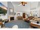 Spacious living room with a fireplace, large screen TV, and an open concept design at 1103 Kensington Ct, Safety Harbor, FL 34695