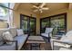 Relaxing covered patio with comfortable seating, perfect for enjoying the outdoors at 1103 Kensington Ct, Safety Harbor, FL 34695