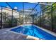 Sparkling pool surrounded by a screened enclosure, providing a private and refreshing oasis at 1103 Kensington Ct, Safety Harbor, FL 34695