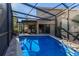 Inviting pool area with a covered patio, perfect for entertaining and relaxation at 1103 Kensington Ct, Safety Harbor, FL 34695
