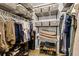 Organized walk-in closet with metal shelving and racks, maximizing storage space for clothing and accessories at 1103 Kensington Ct, Safety Harbor, FL 34695
