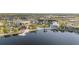 A scenic aerial view of a community showcasing a lake, buildings, and lush landscaping at 11330 Burgundy Dr, Venice, FL 34293