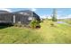 Spacious backyard with screened pool and lush green lawn extending to the water at 11330 Burgundy Dr, Venice, FL 34293