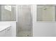 Sleek bathroom with a glass-enclosed shower and neutral tile at 11330 Burgundy Dr, Venice, FL 34293