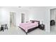 Light-filled bedroom featuring tiled floors and multiple doorways at 11330 Burgundy Dr, Venice, FL 34293