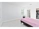 Minimalist bedroom with neutral walls, floors and views to a closet and Primary bath at 11330 Burgundy Dr, Venice, FL 34293