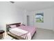 Bright bedroom featuring neutral walls and floors with window views and ensuite at 11330 Burgundy Dr, Venice, FL 34293