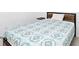 Cozy bedroom featuring a patterned blue and grey bedspread and ample natural light at 11330 Burgundy Dr, Venice, FL 34293