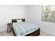 Cozy bedroom featuring a patterned blue and grey bedspread and ample natural light at 11330 Burgundy Dr, Venice, FL 34293