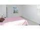 Well-lit bedroom featuring a window and a comfortable bed at 11330 Burgundy Dr, Venice, FL 34293