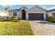 Beautiful single-Gathering home with well-manicured landscaping and a paved driveway at 11330 Burgundy Dr, Venice, FL 34293
