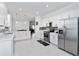 Spacious kitchen with white cabinetry, stainless steel appliances, and light tile flooring at 11330 Burgundy Dr, Venice, FL 34293