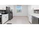 Well-lit kitchen with stainless steel appliances, white cabinets, and a spacious design at 11330 Burgundy Dr, Venice, FL 34293