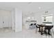 Bright and modern kitchen featuring white cabinets, a quartz countertop, and an island with seating at 11330 Burgundy Dr, Venice, FL 34293